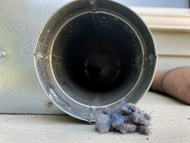 Palm Bay Dryer Vent Cleaning technician using specialized equipment to clear severe dryer vent blockage in Palm Bay
